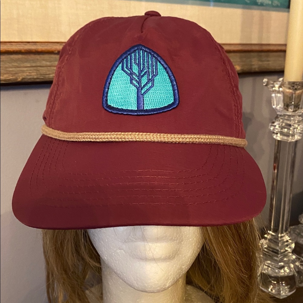 The baseball style cap. It includes a icon patch (the tree logo shown), a rope - Picture 2 of 9